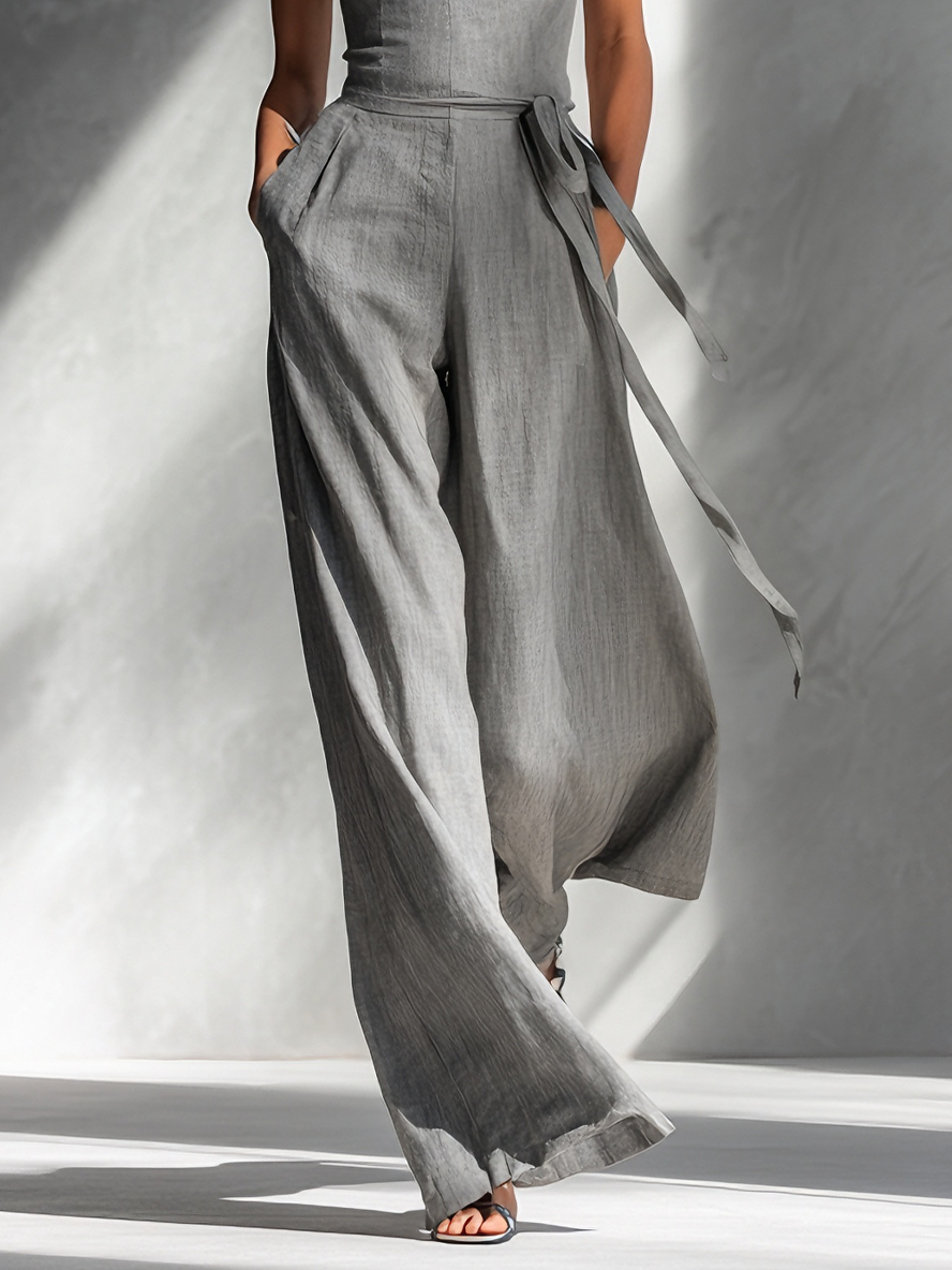 Salopette femme minimaliste en lin gris avec bretelles spaghetti, col carré, ceinture à nouer et pantalons larges MDA2666L5AU
